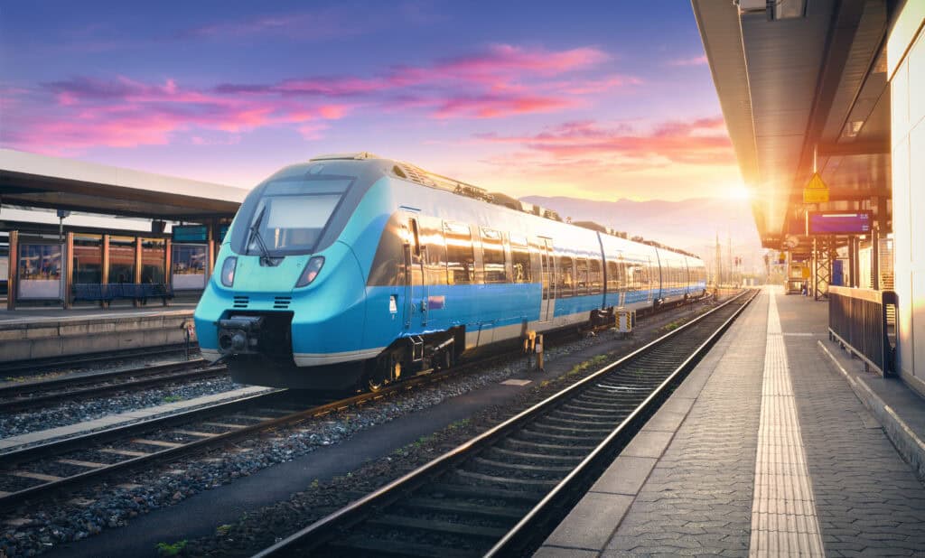 blue modern train at train station at sunset 2026 09 23 00 37 33 utc