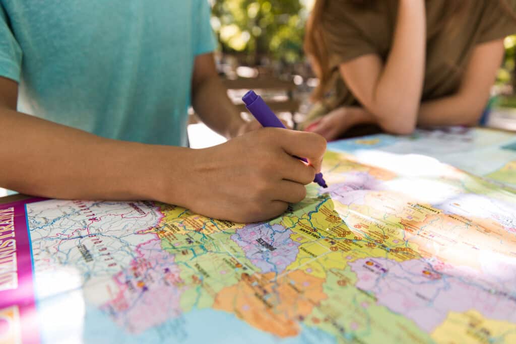 friends planning a european vacation using a map 2026 01 08 05 34 33 utc