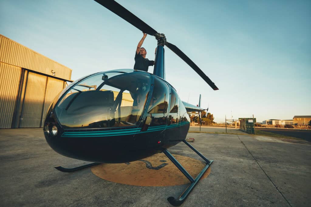 man inspecting helicopter on the tarmac 2026 09 22 14 43 51 utc