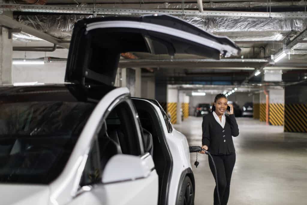 woman charging electric car in parking garage 2026 09 23 02 16 41 utc