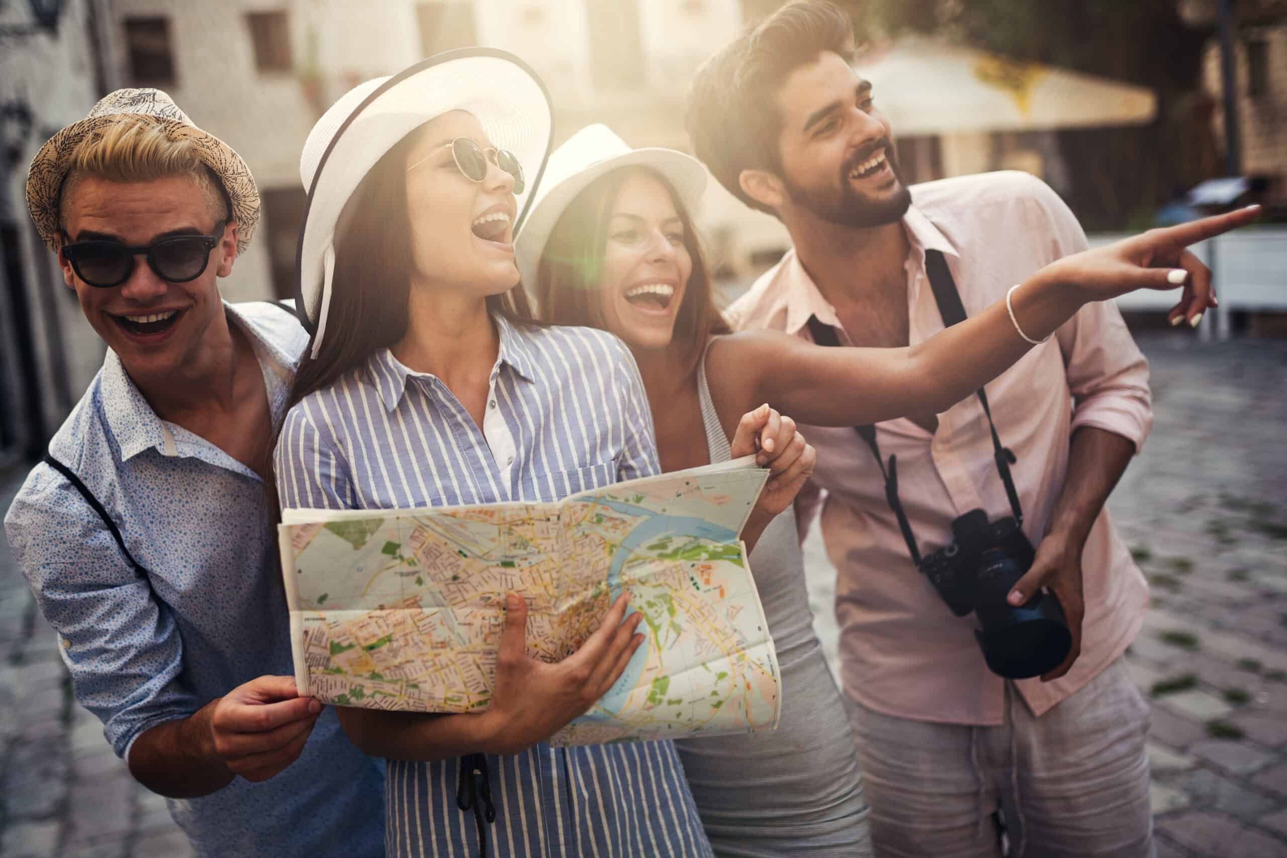 excited friends exploring city with map and camera 2026 09 22 02 58 01 utc