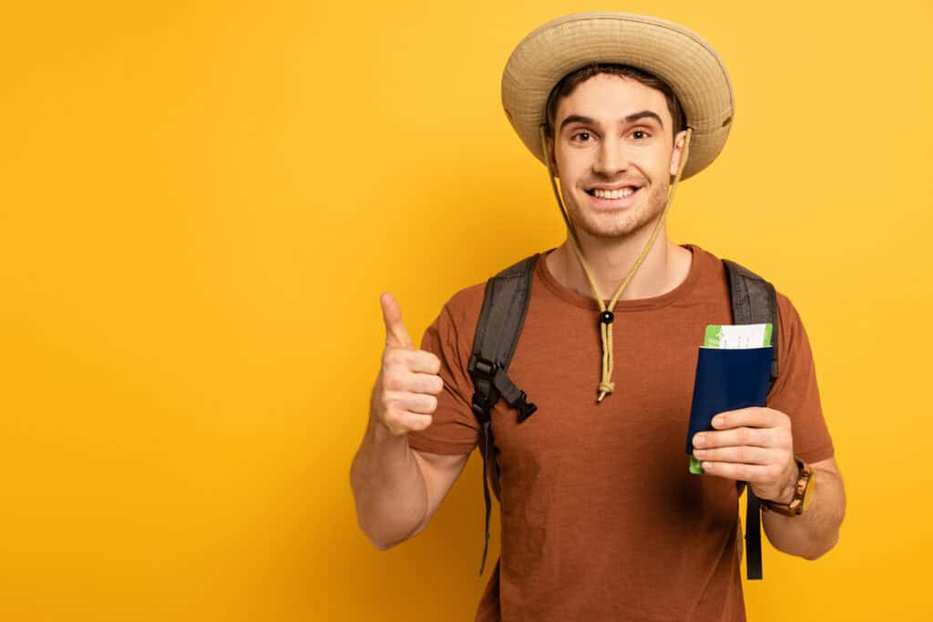 happy traveler showing passport with thumb up 2026 09 21 04 01 59 utc