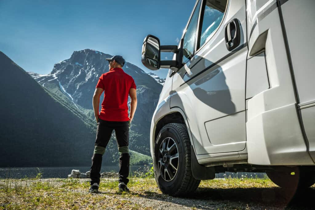 man standing beside campervan in the mountains 2026 09 23 23 09 38 utc