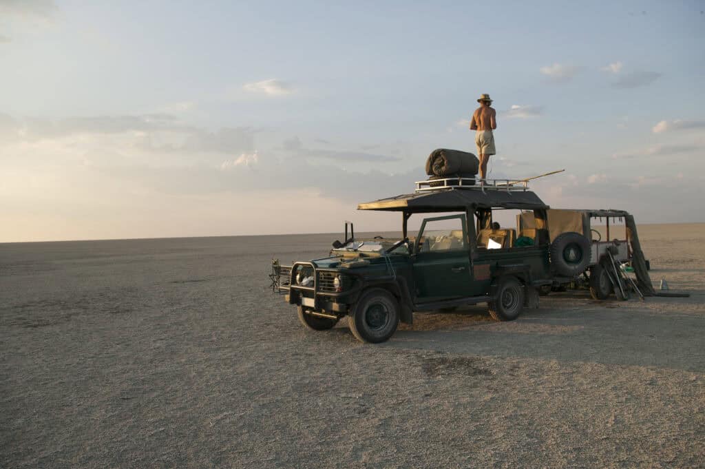man standing on top of 4x4 parked on the makadikad 2026 09 24 13 40 53 utc