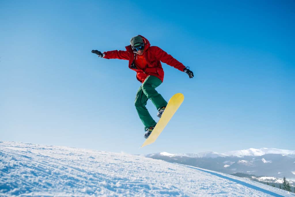 snowboarder gliding through the air atop snowy hil 2026 09 21 10 18 36 utc