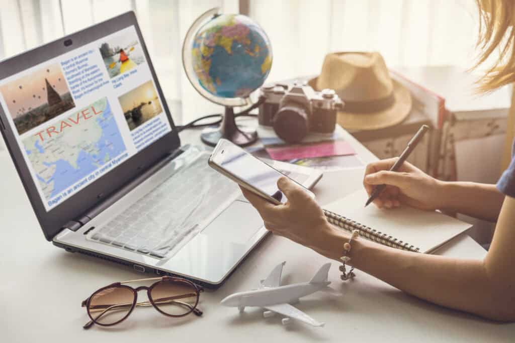 woman planning vacation with globe and laptop 2026 09 23 21 21 16 utc